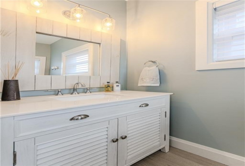 The quiet luxury of the first floor powder room, directly off the entry, allows guests to use the facilities without having to wander the rest of the home.