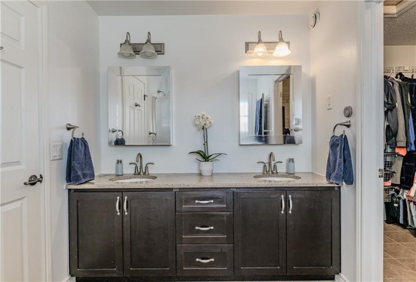 The primary ensuite features dual sinks and serves as a pass through to the large walk-in closet with ample room for two.