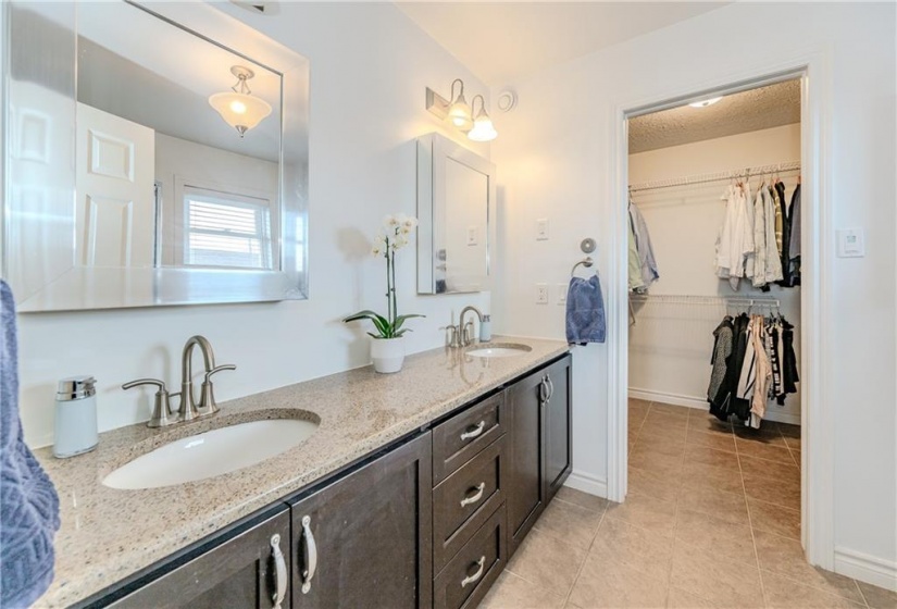 Separate sinks, ample granite countertops, and well-organized storage ease bottlenecks.