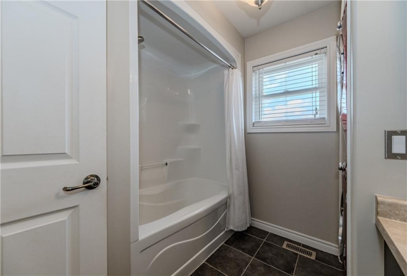 The main bath is both generous and size and handy to both bedrooms.