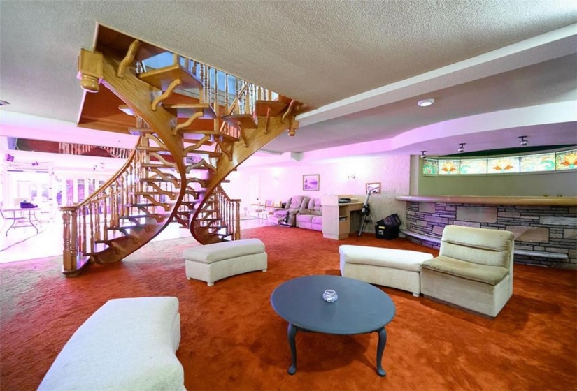 open oak stair case to main level from rec/party room area