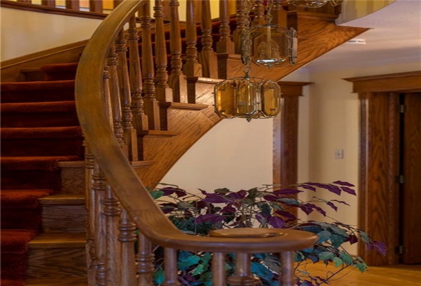 The curved oak staircase impresses as you enter through the foyer. Oak trimming and plaster cove moulding was used throughout, one of the many quality finish choices made to this custom home.