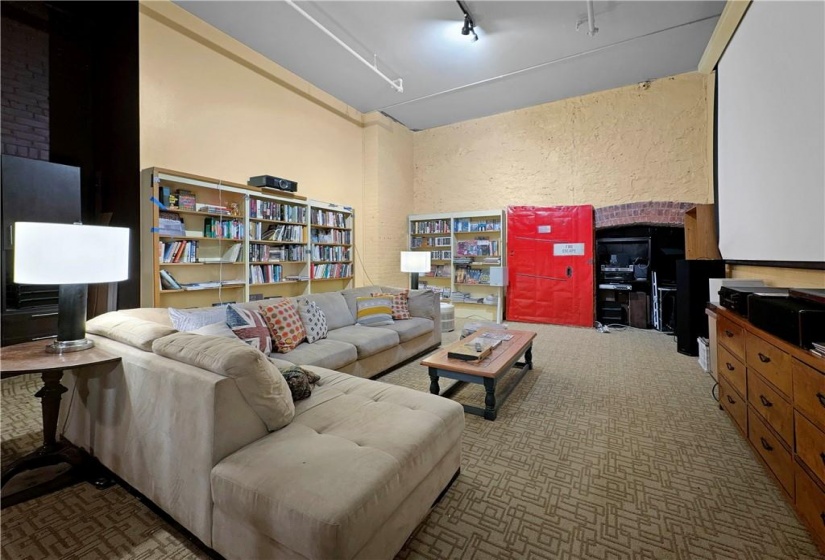 library shelving, original steel fire door, built in murphy bed, and fits a huge sectional sofa