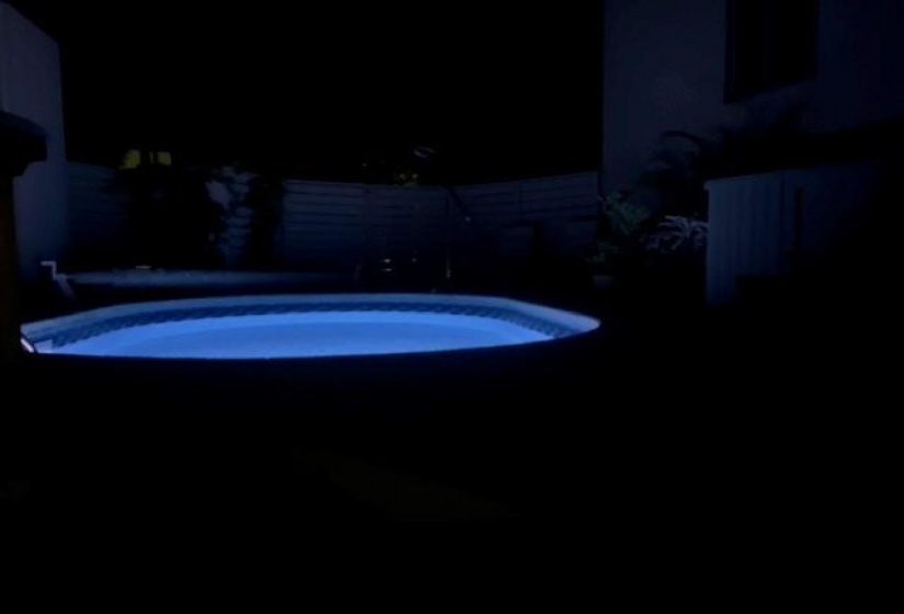 In ground pool lit up at night