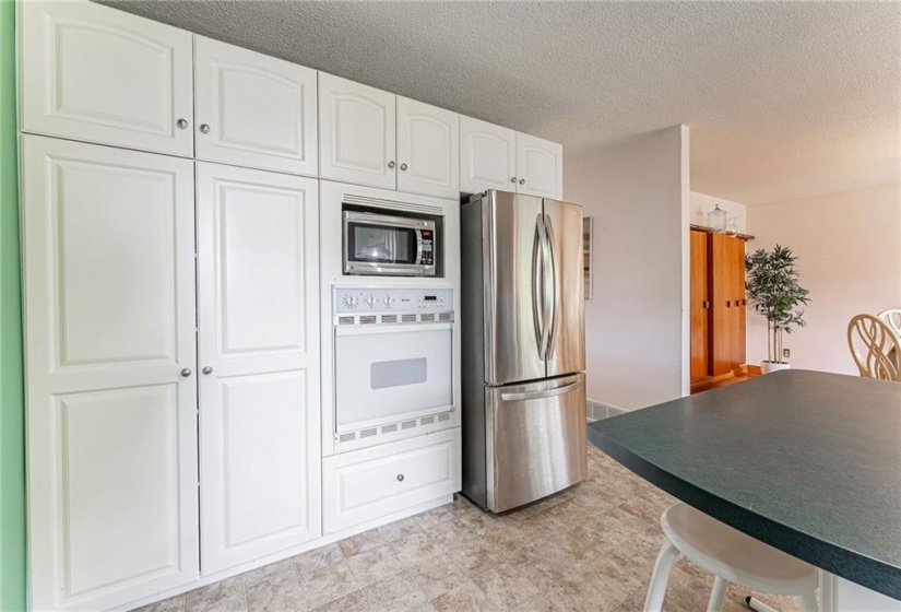 Built-in appliances & large breakfast bar makes for a super functional work space!