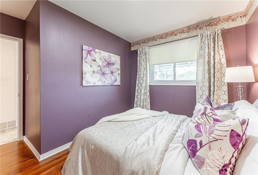 Primary bedroom with large window & double closet with organizers & LED light