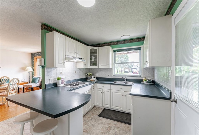 Updated kitchen with built-in appliances, gas cooktop & large breakfast bar!