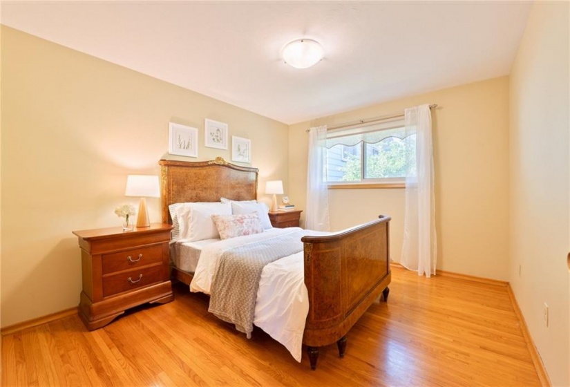 Large primary bedroom with hardwood floor