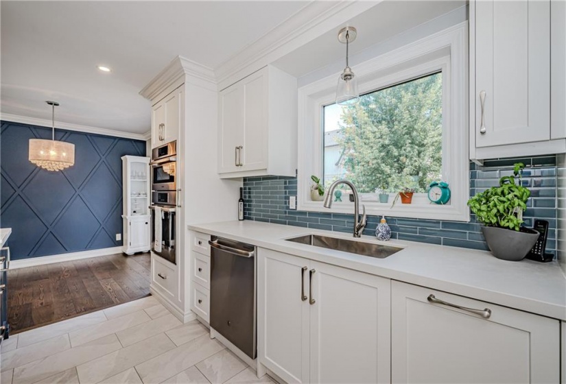 Sliding door access from the dining room shines light on the focal wall in beautiful blue. Walk-out to enjoy a soak in the hot tub.