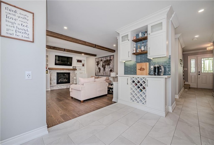 The sunken family room offers a cosy space for the family to reconvene at the end of a busy day. Beamed ceilings overhead offer a modern farmhouse feel to the space.