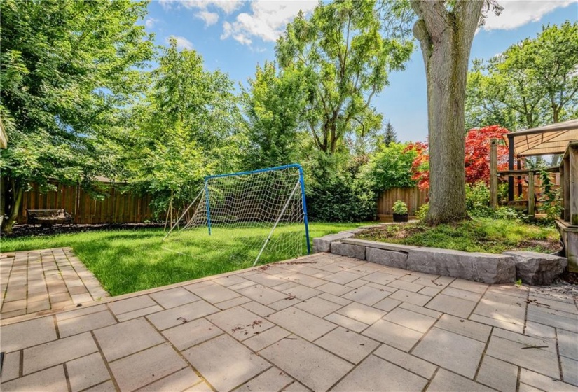 Landscaping includes rockery, mature perennials, irrigation (front and back) as well as walk-out to deck and lower patio.