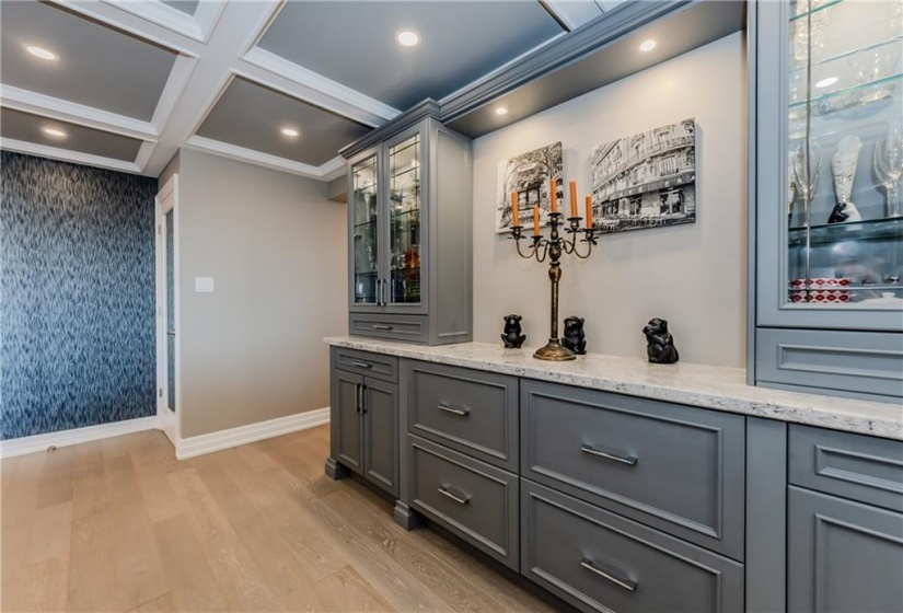 A custom built-in to showcase dishes, liquor collection, as well as kitchen linens and serving wares. The built-in storage closet acts as a walk-in pantry or locker-style storage room.