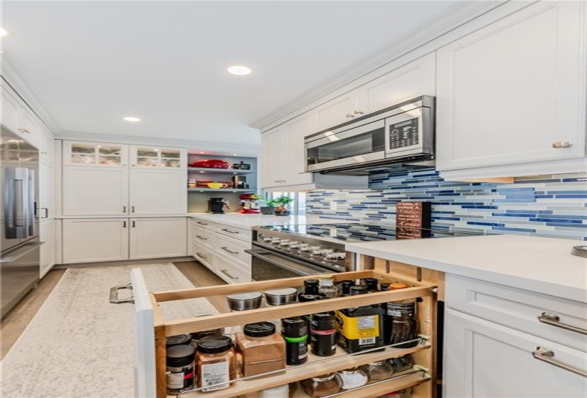 Pull out spice cabinets, soft close cabinetry, full sized pantry... you name it, it's all here!