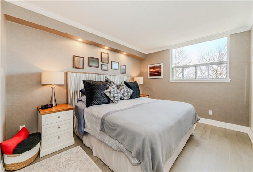 The primary bedroom features an open concept feel to the dressing room.