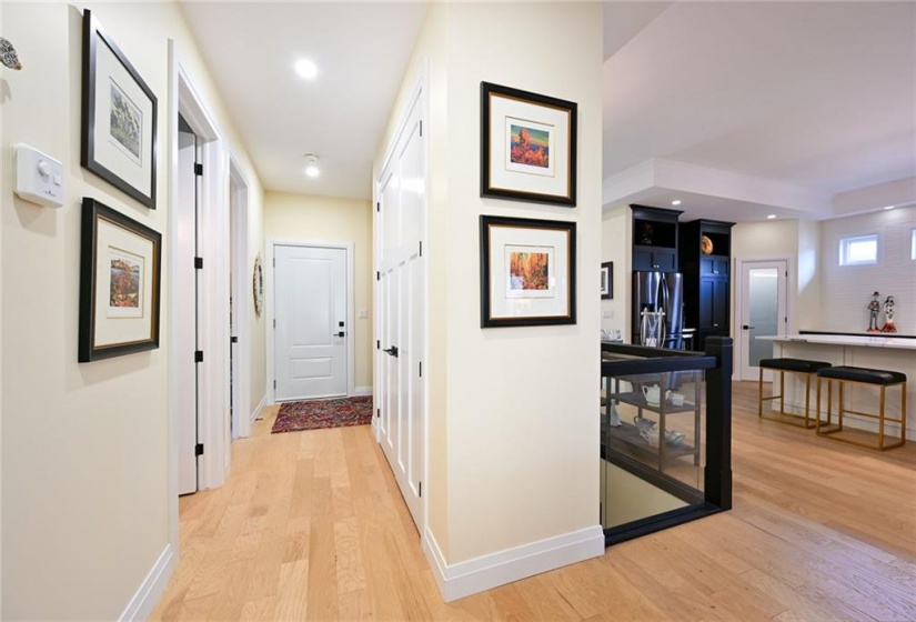 Hall Leading to Oversized 2.5 Car Garage with Epoxy Flooring and Rear Yard Access