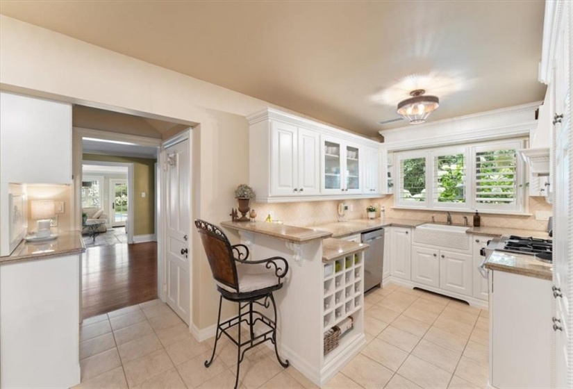 Wine or water rack. Glass fronted cabinetry. 3 deep corner cabinets. Cabinet interiors are laminated. Updated light fixtures. Heated tile floor. Breakfast bar. Bar stool (Elizabeth Interiors) included. Plantation shutters 2023.