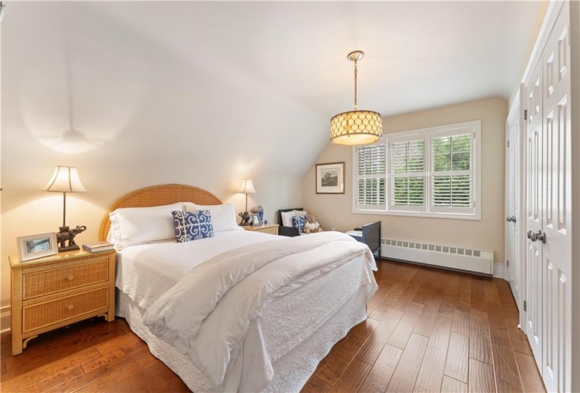 SW bedroom, handscraped maple floor, 2 double closets (plus a closet inside a closet). Replaced light fixture, California shutters. Rad removed and replaced with baseboard style (connected to gas boiler).