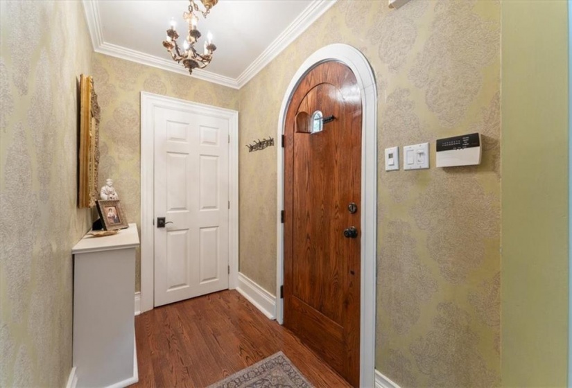 Foyer. High end brass fixture. Speakeasy on front door.