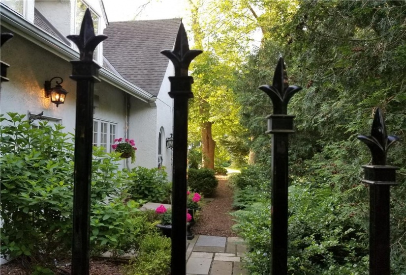 Metal fencing and gate from driveway to west yard. (Older photo)