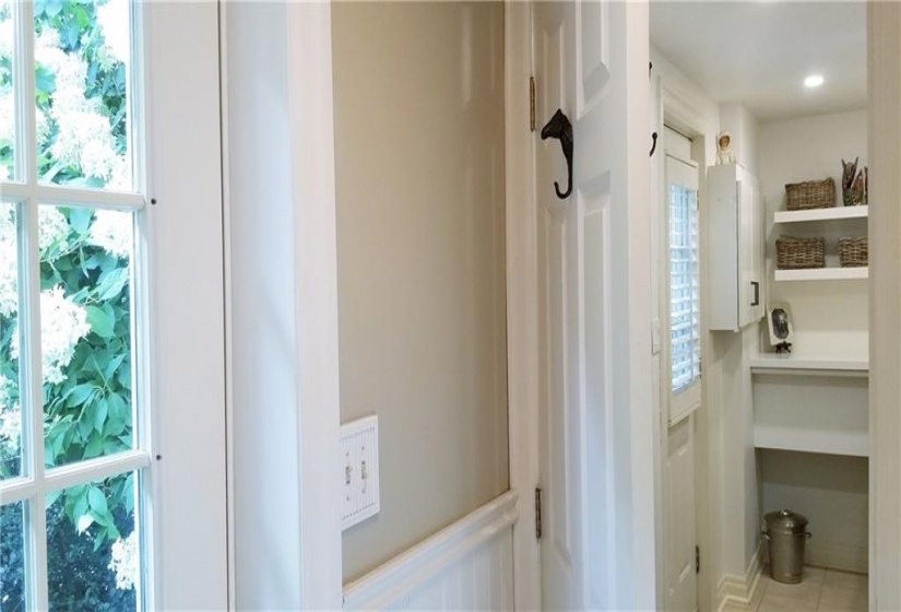 Mudroom & adjacent laundry room. Victorian beadboard wainscotting, clothes closet. Door to side garden.