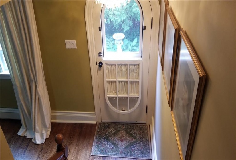 Original front door facing the Ingleside mansion. Door has been restored. Screened, original hardware. Folds down to allow fresh air.