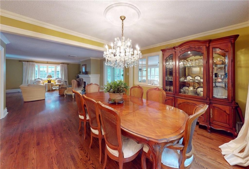 Dining area. Crown moulding, crystal chandelier, dark hardwood. Open to and yet separate from living room