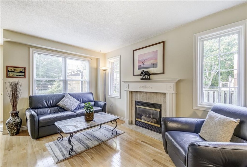 living room with N/gas fireplace, hardwood flooring