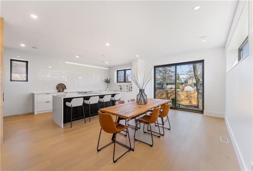 Dining area and kitchen. Sliding doors to glass stairway which leads to private patio.