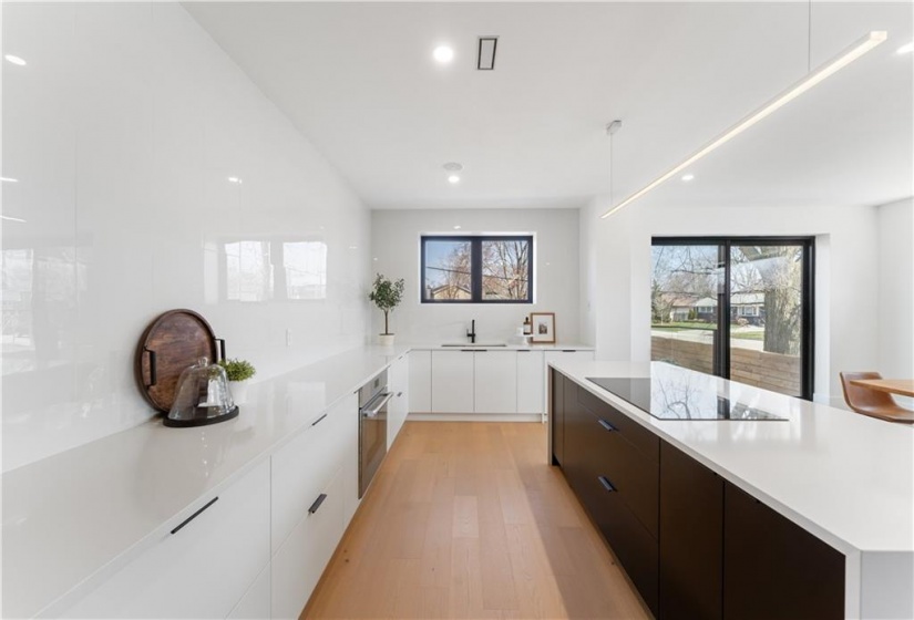 Kitchen with view to sliding doors. Steps down to private fenced patio