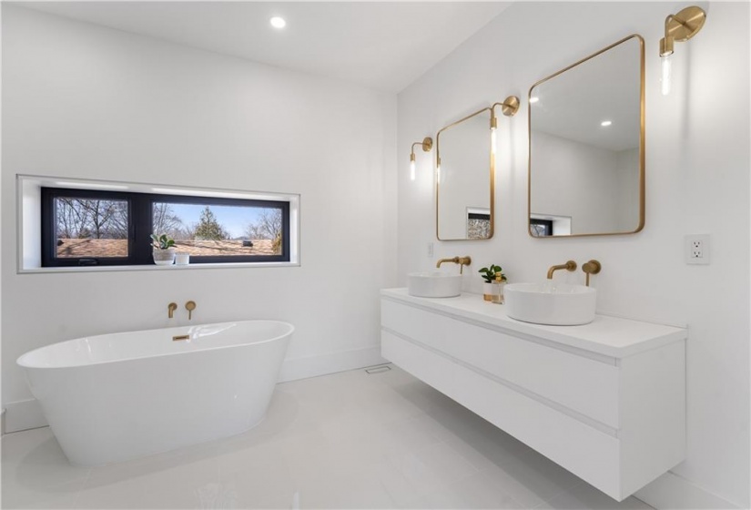 Master ensuite with double vessel sinks, soaker tub. Porcelain floor