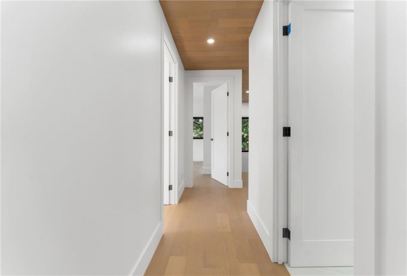 Upper hallway. Pot lighting. White oak flooring and ceiling. 9 foot ceilings.