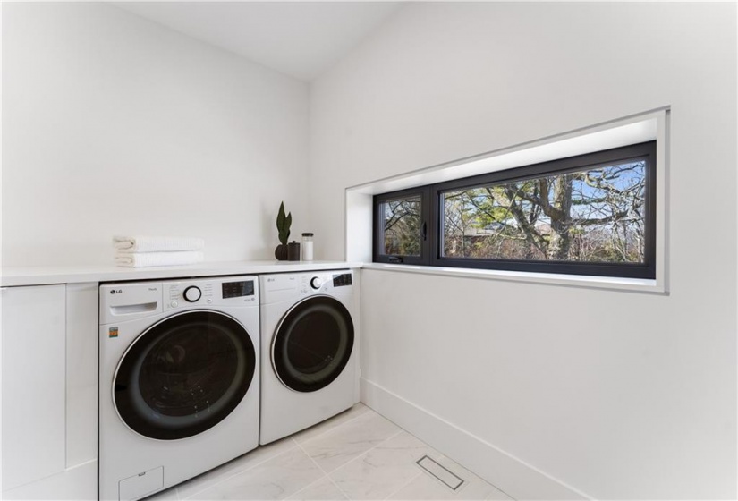 Laundry within spacious main bathroom. Heated floor.