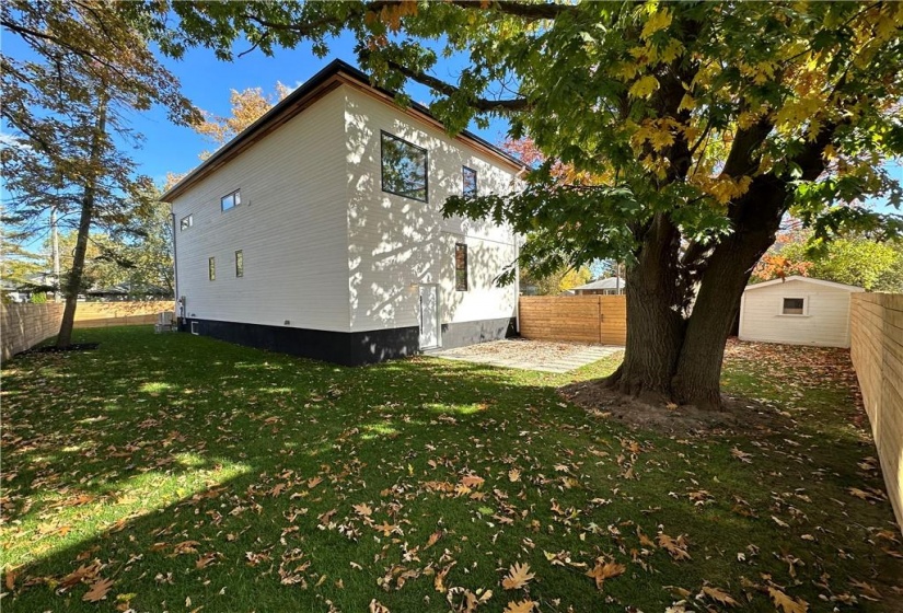 Back and side yard, facing front gate. Side door to mudroom. Fully fenced.