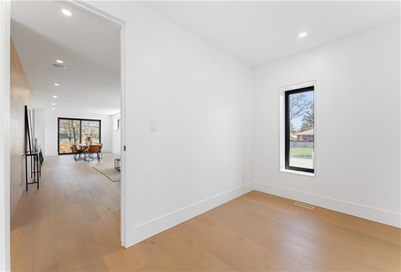 View from corner office to living area. Door for privacy.