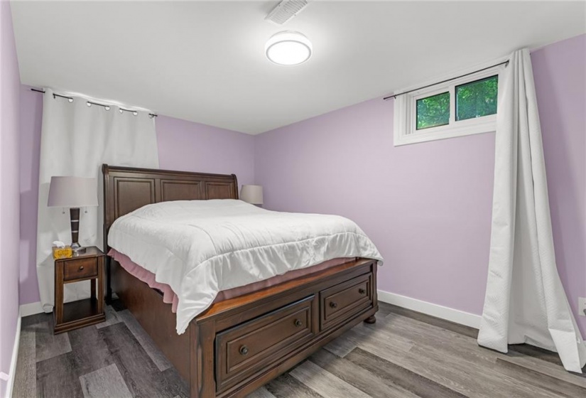 Lower level bedroom with wall electric fireplace