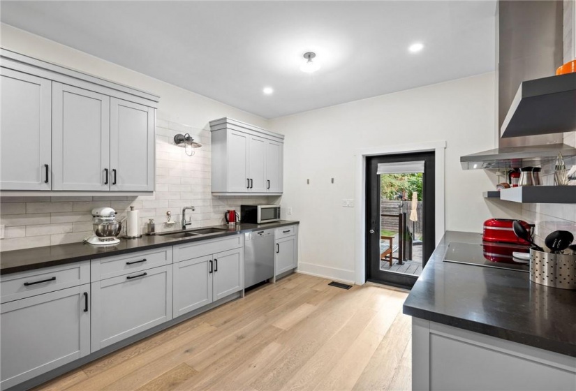 Kitchen on main-floor: new exterior door (2018) leading to backyard