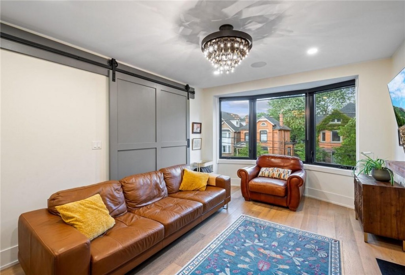 Living room in upper unit (2nd flr). Note the large bay window!