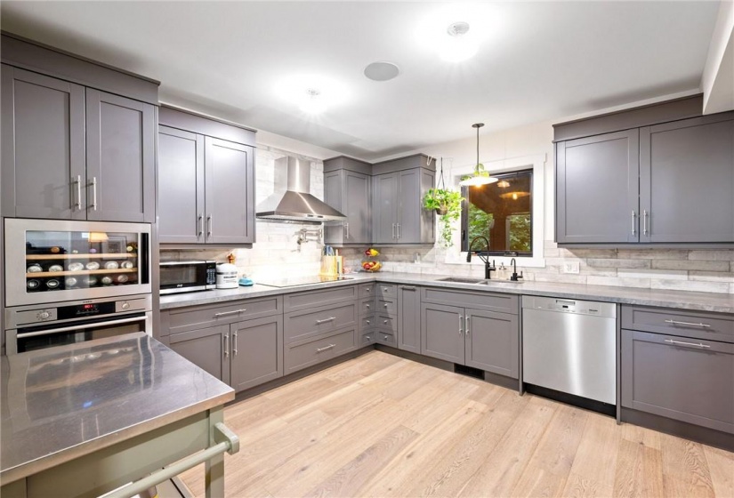 Kitchen in upper unit (2nd flr). Note the built-in wine fridge!