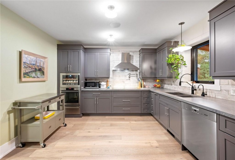 Kitchen in upper unit (2nd flr). Soft close cabinetry including hidden garbage/recycling and designated spice drawer!