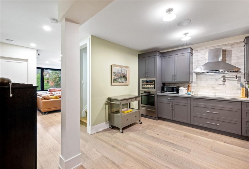 Kitchen in upper unit (2nd flr). Built-in oven with warming drawer, built-in stove top with hood vent and pot-filler!