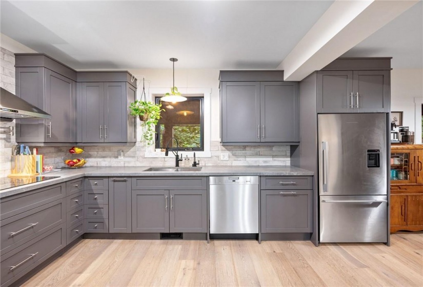 Kitchen in upper unit (2nd flr). Built-in oven with warming drawer, built-in stove top with hood vent and pot-filler!