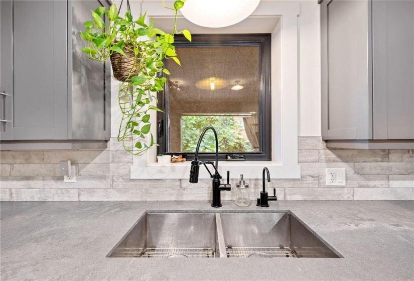 Kitchen in upper unit (2nd flr). Double undermount sink, large window (all windows replaced in 2018) overlooking deck/backyard