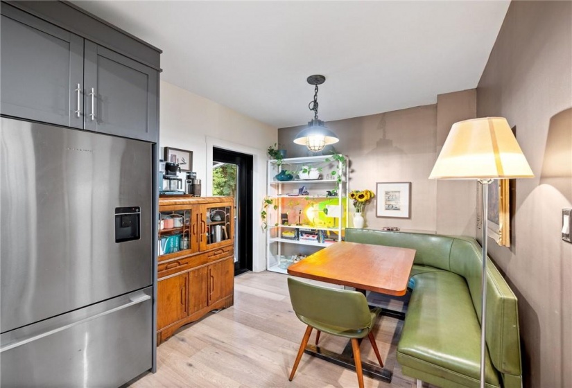 Kitchen in upper unit (2nd flr). Eat-in area leading to expansive (private) balcony!