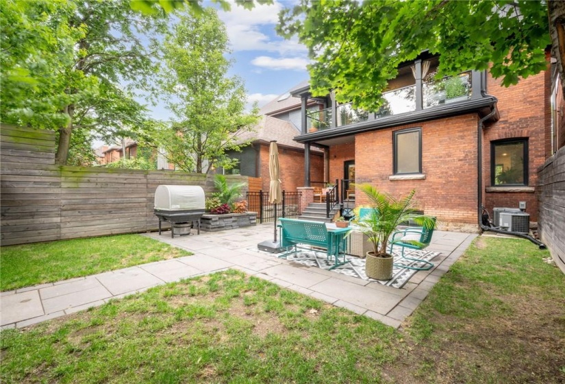 Large (and private) yard surrounded by mature trees, extensive patio with walkway, and fully fenced