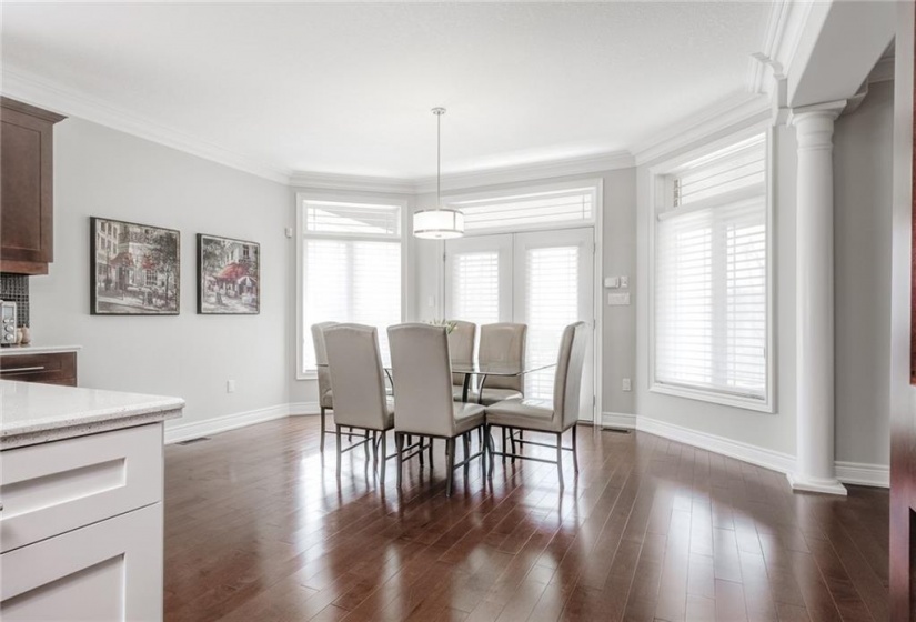 Dinette flanked by Floor to Ceiling Windows & Garden Doors