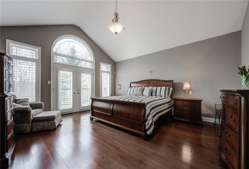 Primary Bedroom with Vaulted Ceiling, 10’ Window with Juliette Balcony