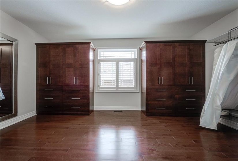 Primary Walk-In Closet features Maple Built-In Cabinets