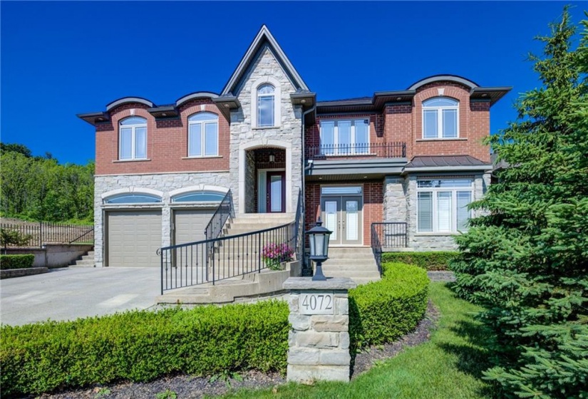 Timeless Brick & Stone Exterior with Limestone accents and Iron rails