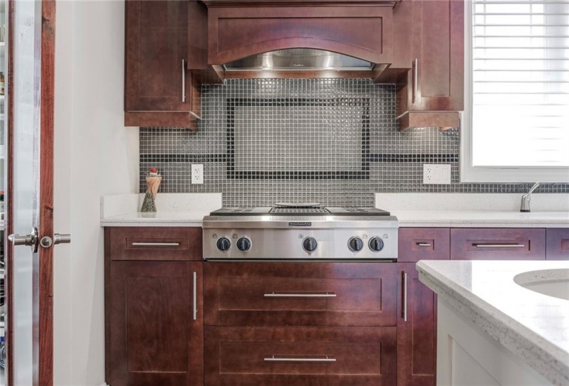 Built-In Gas Cooktop with Grill and Glass Tile Backsplash